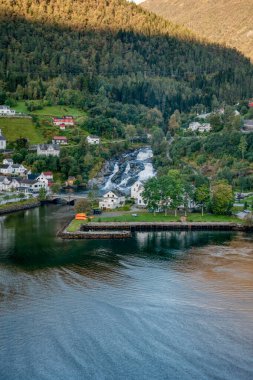 Büyüleyici bir köy manzarası. Büyüleyici bir şelale ve fiyort çevresi yemyeşil.