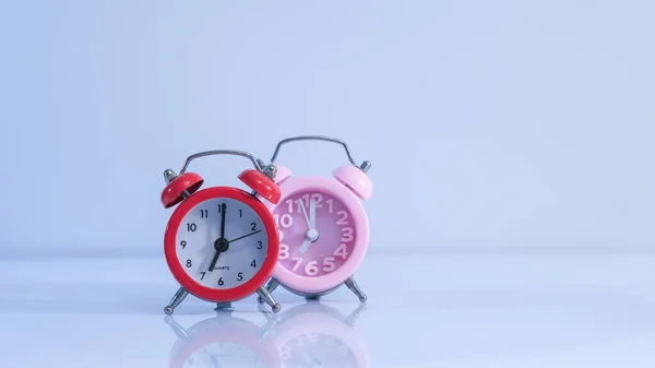 pink and red alarm clocks