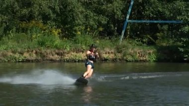 Göl kenarındaki Wakeboardcu Temmuz 2021 'de Ukrayna' daki Zhytomer 'de kalmak üzere trenlere biner. Olağanüstü bir spor. Suya doğru kay. Yüksek kaliteli HD görüntüler