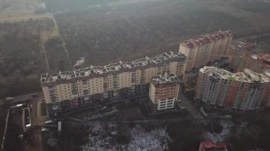 a view from a height from a quadrocopter drone to the new buildings of a new city building in Ukraine in Zhytomer in February 2020. Apartment buildings, streets, city, architecture. high quality