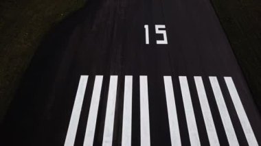 A view of the airport drone filming the runway where different planes take off and land. Long road, desert, scale. First-person view. Acceleration on asphalt. High quality 4k footage