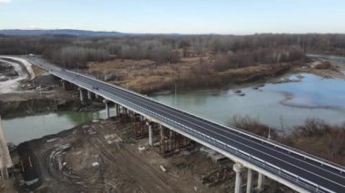 Construction site of a bridge across the road . Bird eye. big faucet. Aerial view of the construction of the bridge. Aerial view of the infrastructure flyover across the river. High quality FullHD