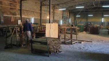 Production line of the wooden floor factory. CNC automatic woodworking machine. Industrial . Woodworking machine. High quality FullHD footage