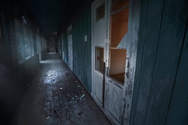  Lost place. Abandoned sanatorium decomposes with time. Broken doors, broken windows. Long corridor. High quality photo
