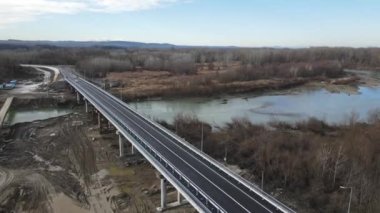Construction site of a bridge across the road . Bird eye. big faucet. Aerial view of the construction of the bridge. Aerial view of the infrastructure flyover across the river. High quality FullHD