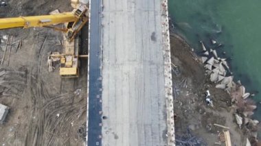 Construction site of a bridge across the road . Bird eye. big faucet. Aerial view of the construction of the bridge. Aerial view of the infrastructure flyover across the river. High quality FullHD