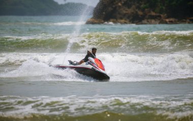 Weligama, Sri Lanka - 10 29 2022: Jet ski rider making a turn, having fun in the ocean.
