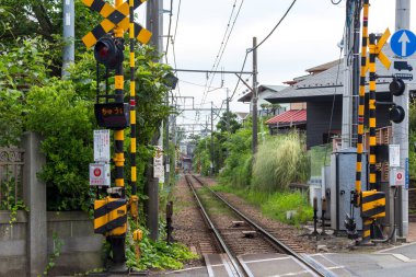 Road crossing and railway tracks in Kamakura, Japan.
