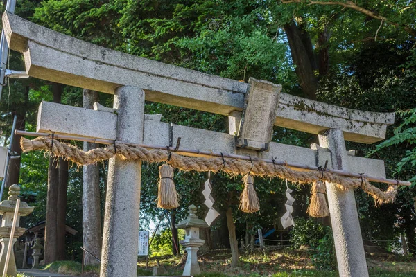 Kutsal ip, ya da shimenawa, ve zigzag flamalar, ya da kalkan, torii kapısı üzerinde küçük yerel tapınak, Kanazawa, Japonya.