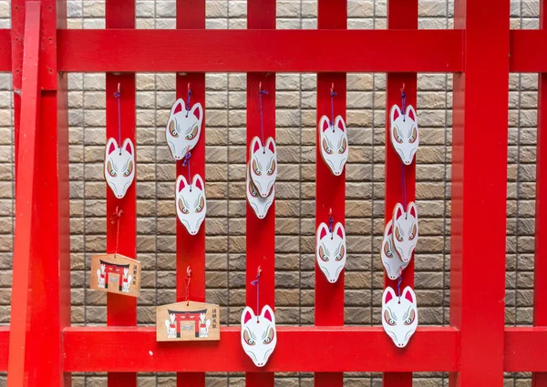 Red and white fox masks at Asanogawa inari jinja, Kanazawa, Japan.