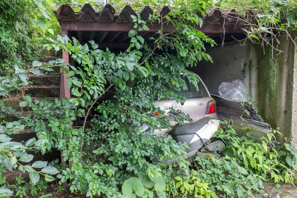 Abandoned car in abandoned building, Yamashina, Kanazawa, Japan