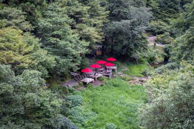 Outdoor tea house, Ayatori Bridge, also known as  the Cat's Cradle Bridge, over the Daishoji River at Kakusenkei Gorges, Yamanakaonsen, Kaga, Ishikawa, Japan clipart