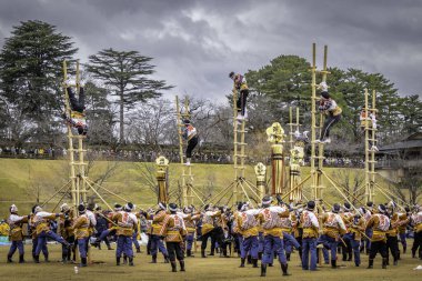 Firefighters perform acrobatics at the annual Kaga-tobi Dezomeshiki Festival, Kanazawa, Japan TRANSLATION: kanazawa clipart