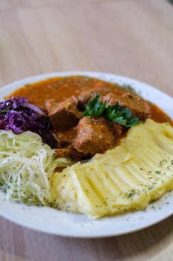 Patates püresi ve salata ile güveç.