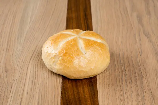 Koyu ve açık ahşap bir masada çıtır çıtır ekmek. Pastayı ısıtır. Yıldız işaretleri bırakır.