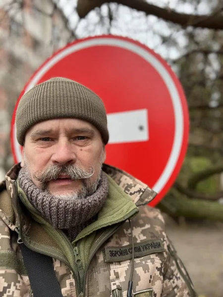 face of an elderly mature Ukrainian soldier with  inscription 