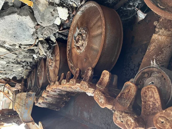 Rusty caterpillars of a burnt tank after being hit by rocket during war