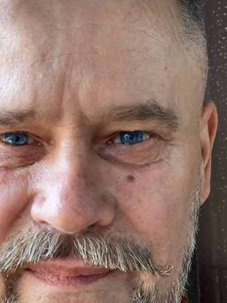 face of an elderly Ukrainian soldier during the war, looking directly into camera