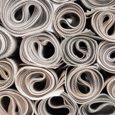 Stack of newspapers rolls, paper texture background. clipart