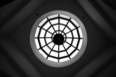 The view from inside the room to the dome with caissons, which completes the round window through which the daylight enters clipart