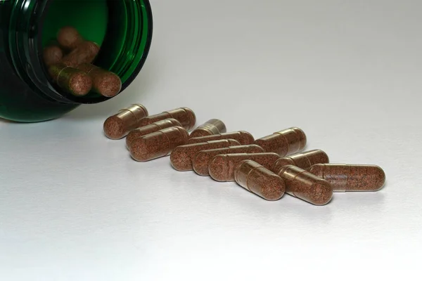 Closeup Herbal Supplement Pills Spilling Out Green Bottle Stock Picture