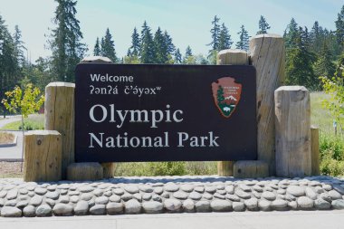 Entrance sign for Olympic National Park on the road to Hurricane Ridge. clipart