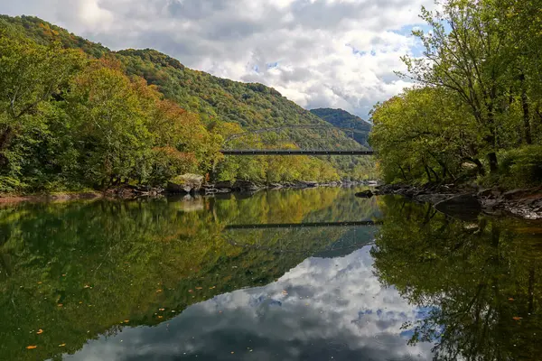 stock image Mountains and bridge reflecting in the New River in Autumn