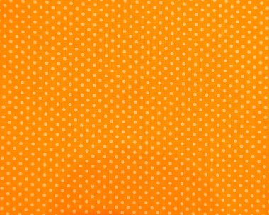 Turuncu ve sarı benekli kumaş arkaplanının tam çerçeve yakın çekimi