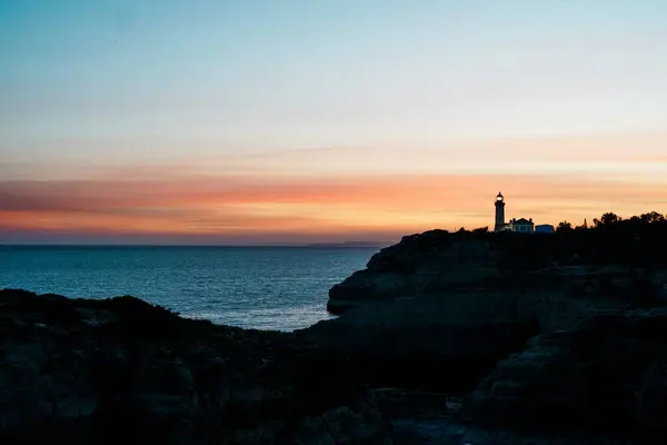 stock image The wild and scenic limestone coast of the Algarve, Portugal, with the Alfanzina Lighthouse. Between Benagil and Alfanzina.