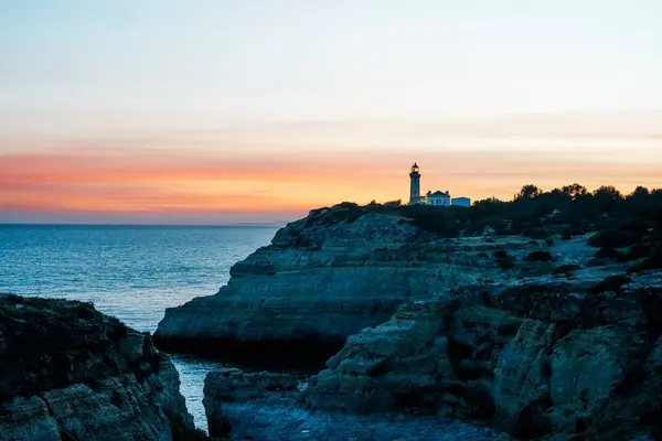 stock image The wild and scenic limestone coast of the Algarve, Portugal, with the Alfanzina Lighthouse. Between Benagil and Alfanzina.