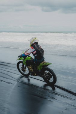  Enduro Adventure on Bali's Black Sand Beach. Off-Road Motorbike Experience. clipart