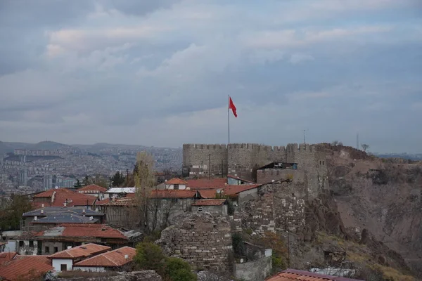 stock image Ankara Castle on blue sky background with flag waving under the moon