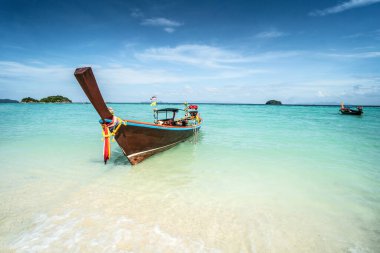 Long tail boat on tropical beach, Koh Lipe island, Thailand. Summer vacation, holiday concept. Blue sky. Tourism