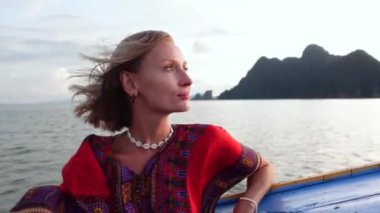 Happy woman on the sunset boat trip. Tropical summer vacation. Serene people. Thailand. Traveler.Tourism.