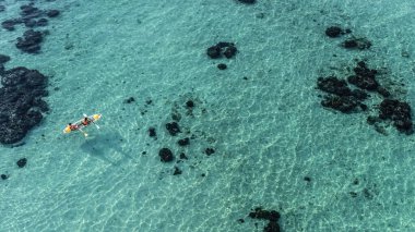 Aerial view of transparent kayak on the tropical blue sea. Seaspace. A lot of copy space.