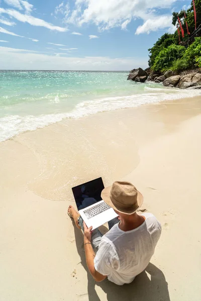 Muž Letním Klobouku Obchodník Digitální Nomád Pracující Laptopem Písečné Pláži — Stock fotografie