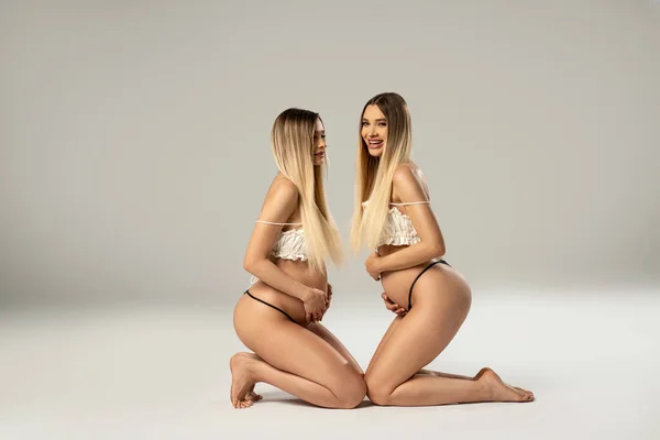 Conceptual Photo Two Beautiful Pregnant Twins Sisters Posing Together Studio — Stock Photo, Image
