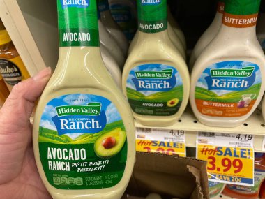 Grovetown, Ga USA - 01 13 23: Grocery store Hand holding Hidden Valley ranch dressing avocado