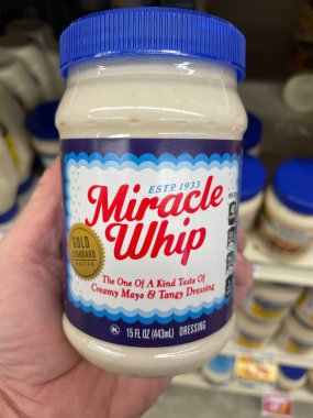 Grovetown, Ga USA - 01 13 23: Grocery store Hand holding Miracle Whip mayonnaise