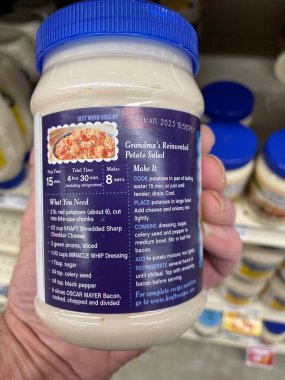 Grovetown, Ga USA - 01 13 23: Grocery store Hand holding Miracle Whip mayonnaise recipe