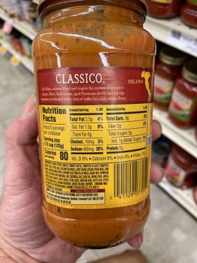 Grovetown, Ga USA - 01 13 23: Grocery store Hand holding Classico spaghetti sauce ingredients label