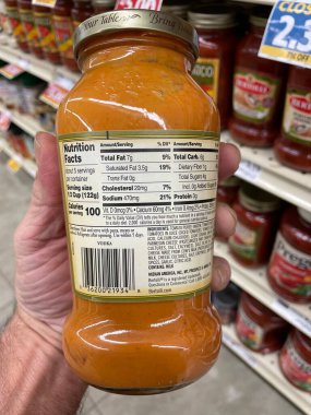 Grovetown, Ga USA - 01 13 23: Grocery store Hand holding Bertolli spaghetti sauce ingredients label