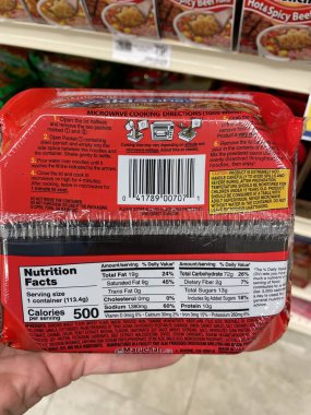 Grovetown, Ga USA - 01 13 23: Grocery store Hand holding ingredients label yakisoba noodles