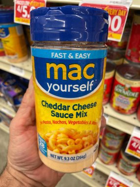 Grovetown, Ga USA - 01 13 23: Grocery store Hand holding MAC yourself cheese sauce mix
