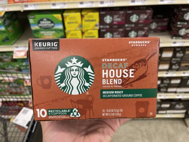Grovetown, Ga USA - 01 15 23: Grocery store hand holding Starbucks k cup coffee house blend