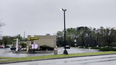 Grovetown, Ga USA - McDonalds fast food restaurant exterior rainy day clipart