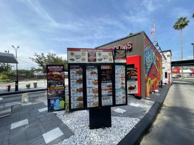 Lakeland Fla, USA - 05 18 24: Checkers fast food drive thru menu and signs clipart