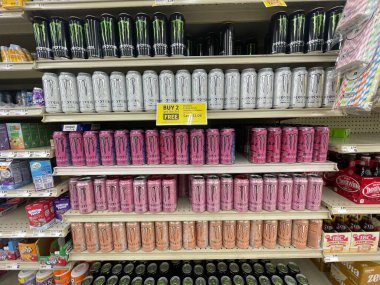 Lakeland Fla, USA - 05 19 24: Harveys grocery store interior Monster energy drink display and prices clipart