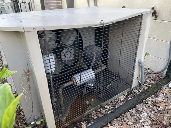 stock image Air conditioner unit exterior damaged side panel rusted components