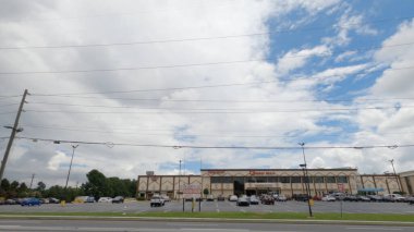 Norcross, Ga USA - 07 29 20: Jimmy Carter BLVD traffic cloudy day Global Mall seen from road clipart